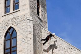 rappelling down a church wall